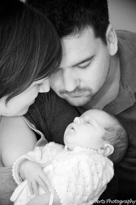 parents looking down at a newborn baby - newborn portrait photography sydney